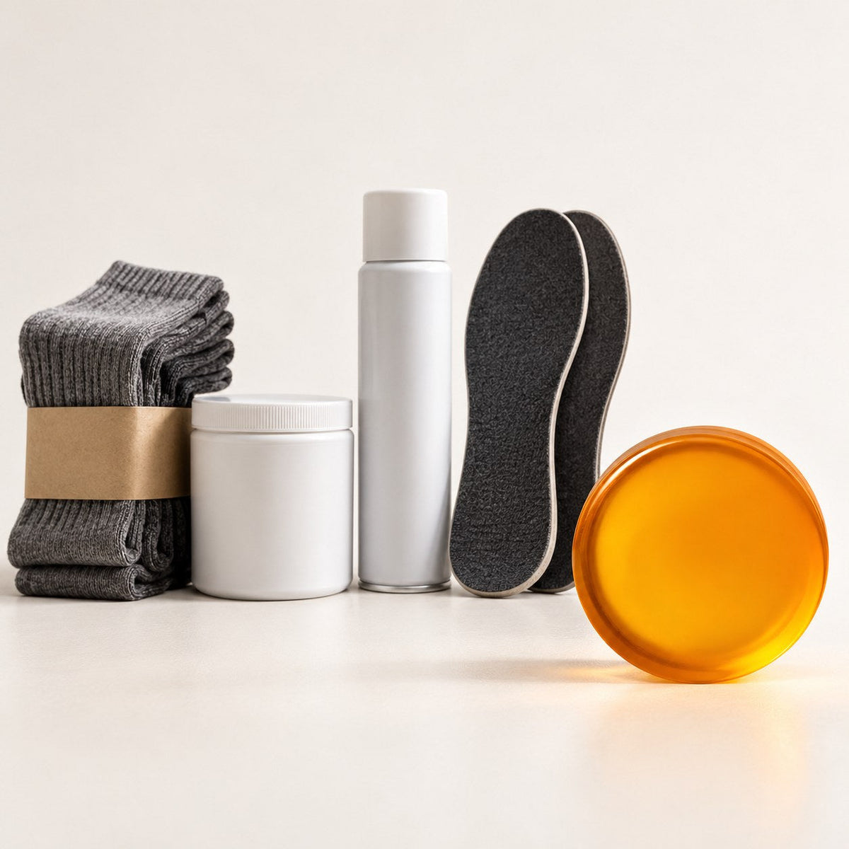 Five foot smell fixes side by side: socks, foot powder, shoe spray, odour insoles and an orange foot bar